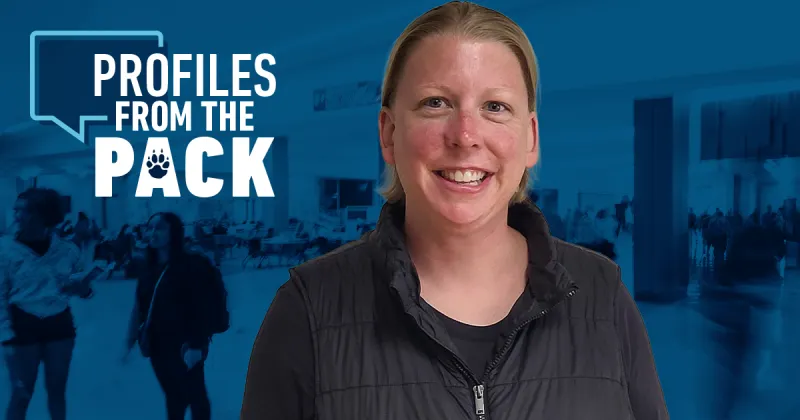 Angie Hoefs facing forward smiling with blue Madison College background behind her.