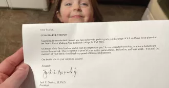 Madison College student Scarlett Wylde-Nunez reads her Dean's List letter as her daughter looks on.