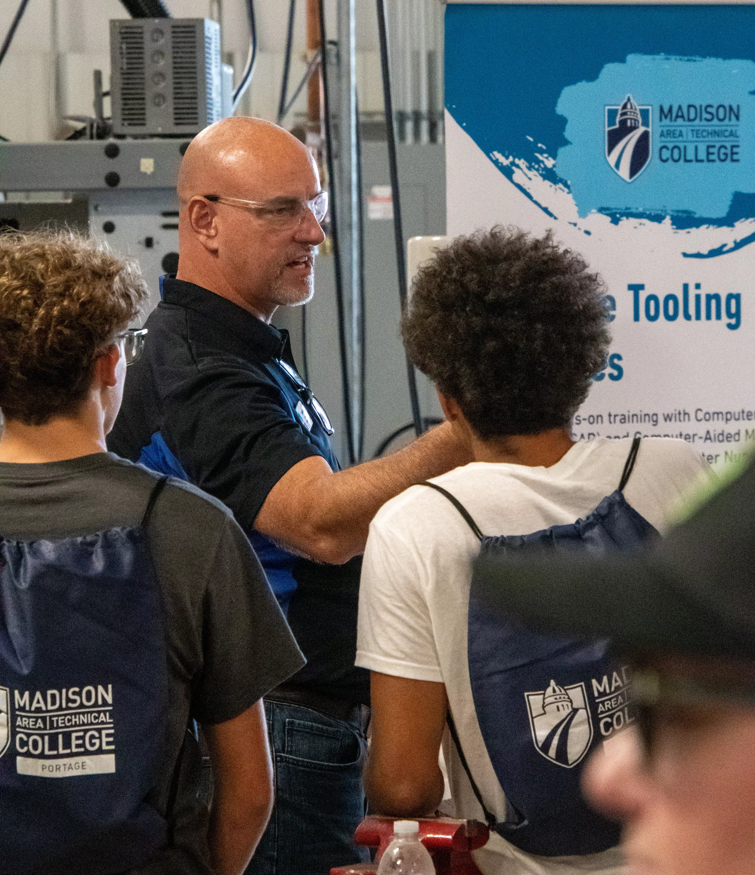 Instructor with high school students at the Skilled Trades Showcase