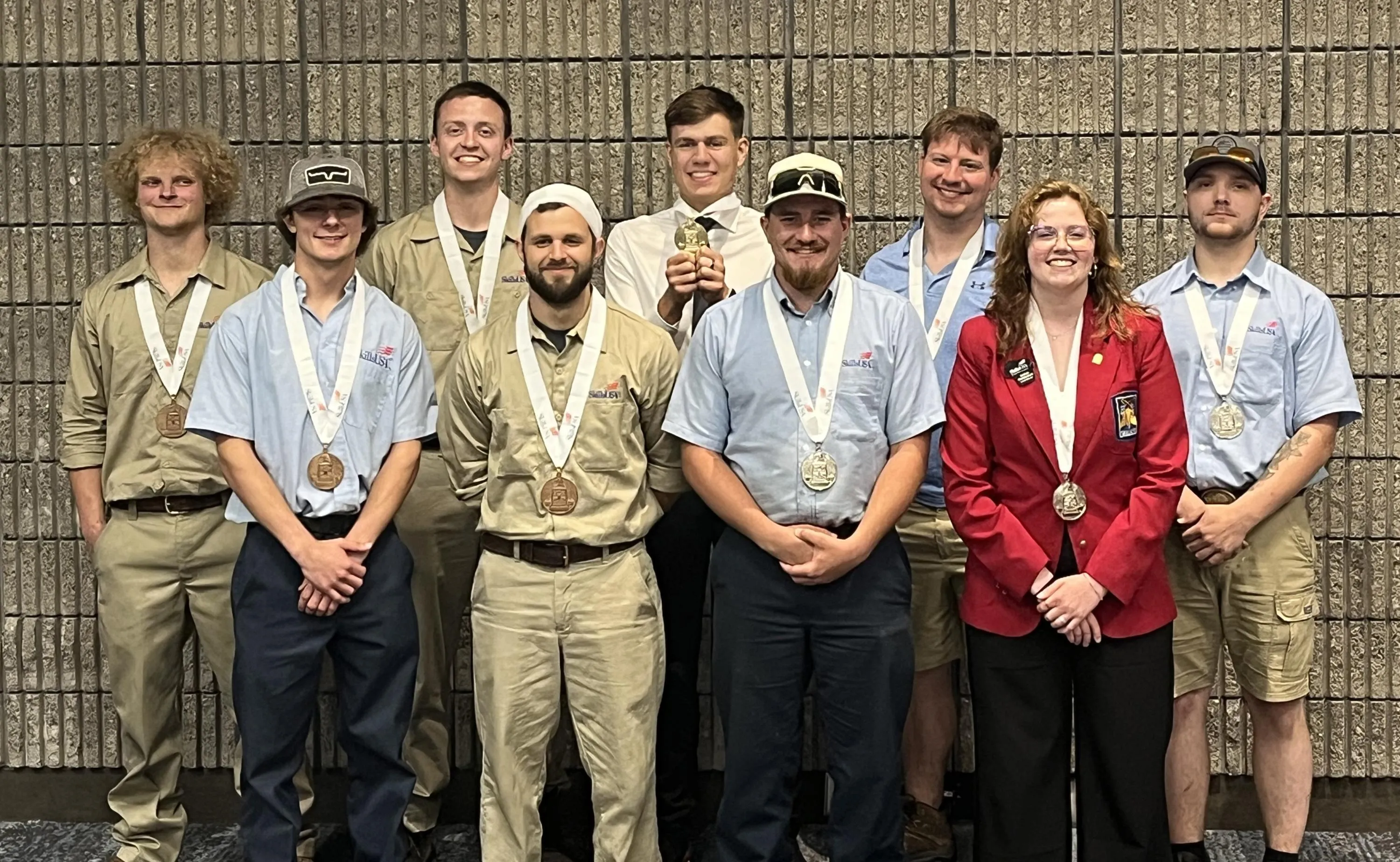 2025 SkillsUSA national medal winner posing with medals around their necks.
