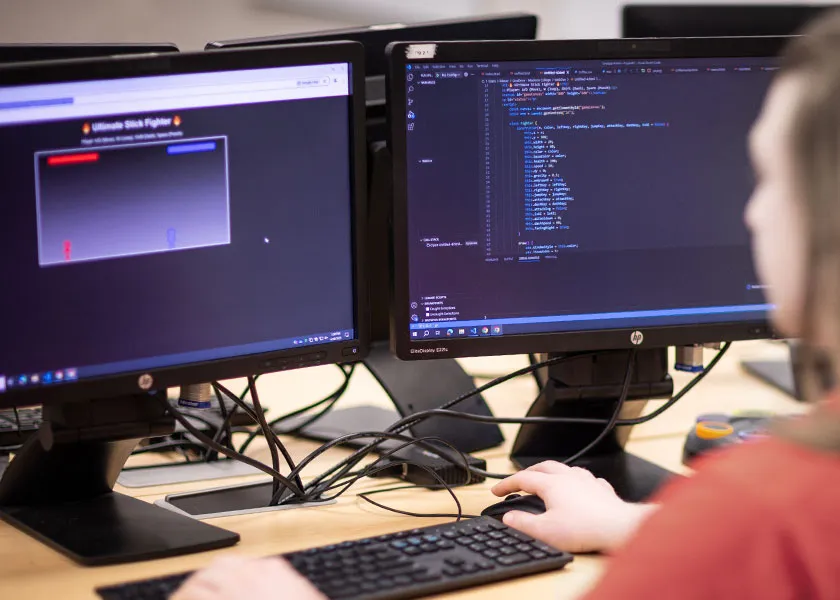 information technology student comparing software code with live views