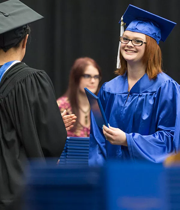 STEM academy student in cap and gown at graduation
