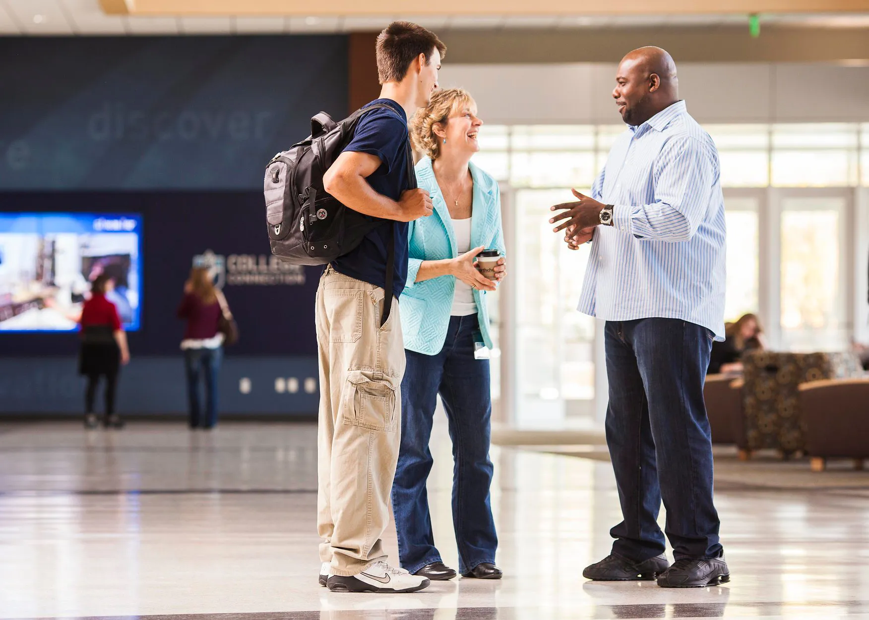 two people talking to a college recuiter