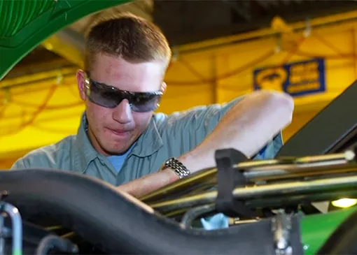 Diesel student working on tractor