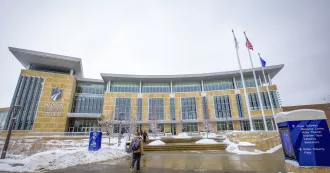 Flags outside main Truax Campus building.