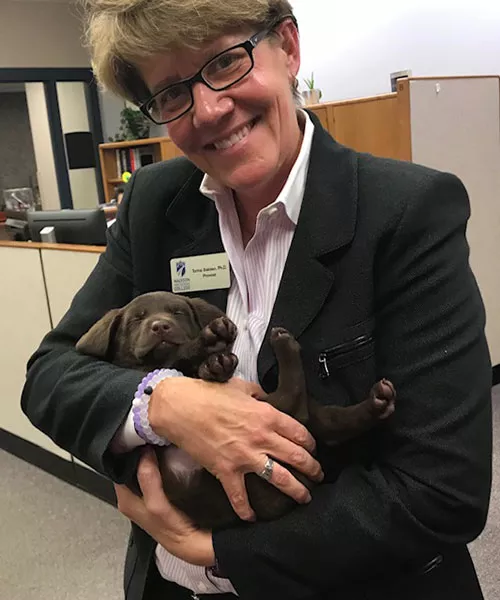 Turina Bakken holding a puppy dog