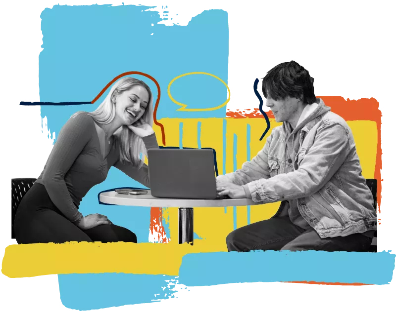 two students sitting together with a laptop